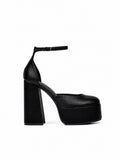 Black platform high heel shoe on a white background
