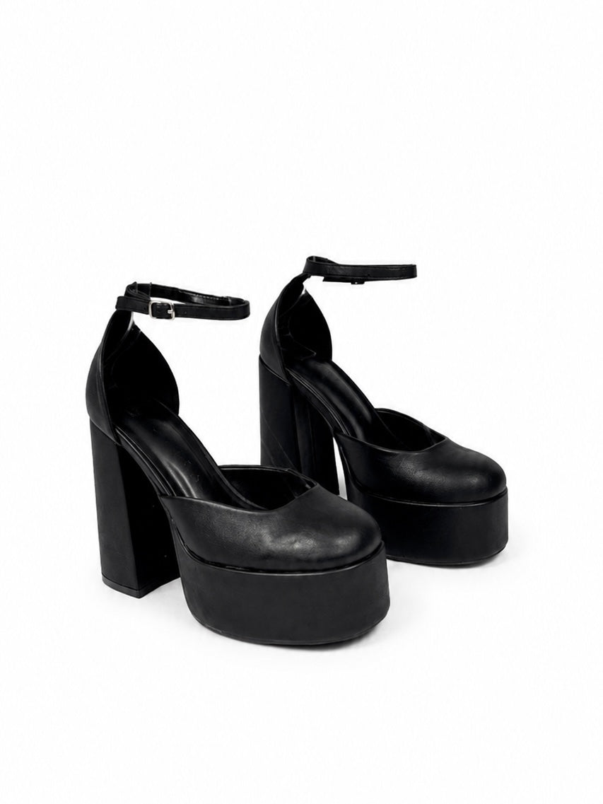 Black platform high heels on a white background