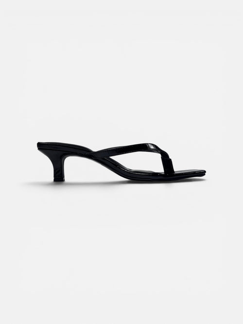 Black crock sandal on a white background
