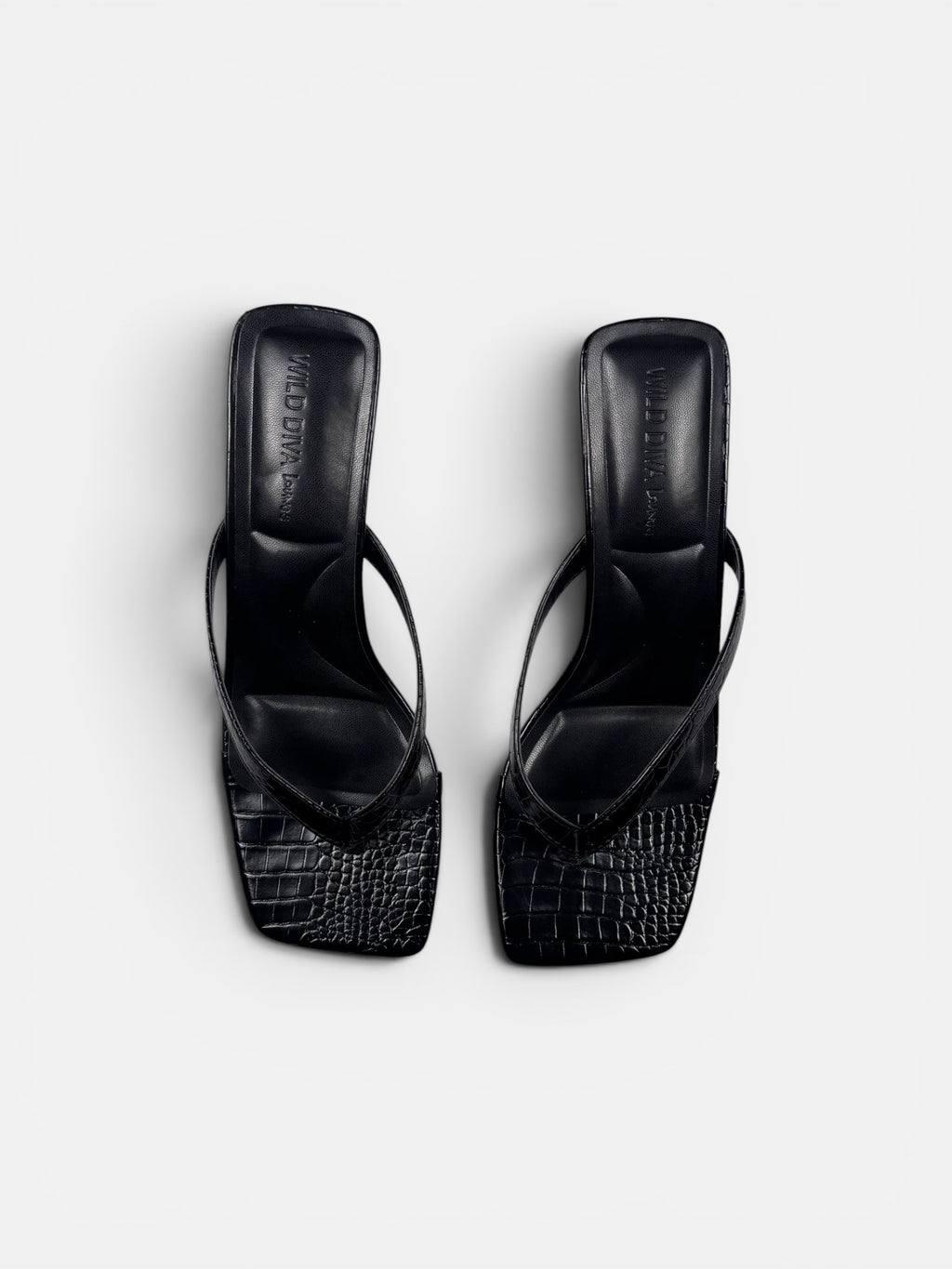Black crock sandal on a white background