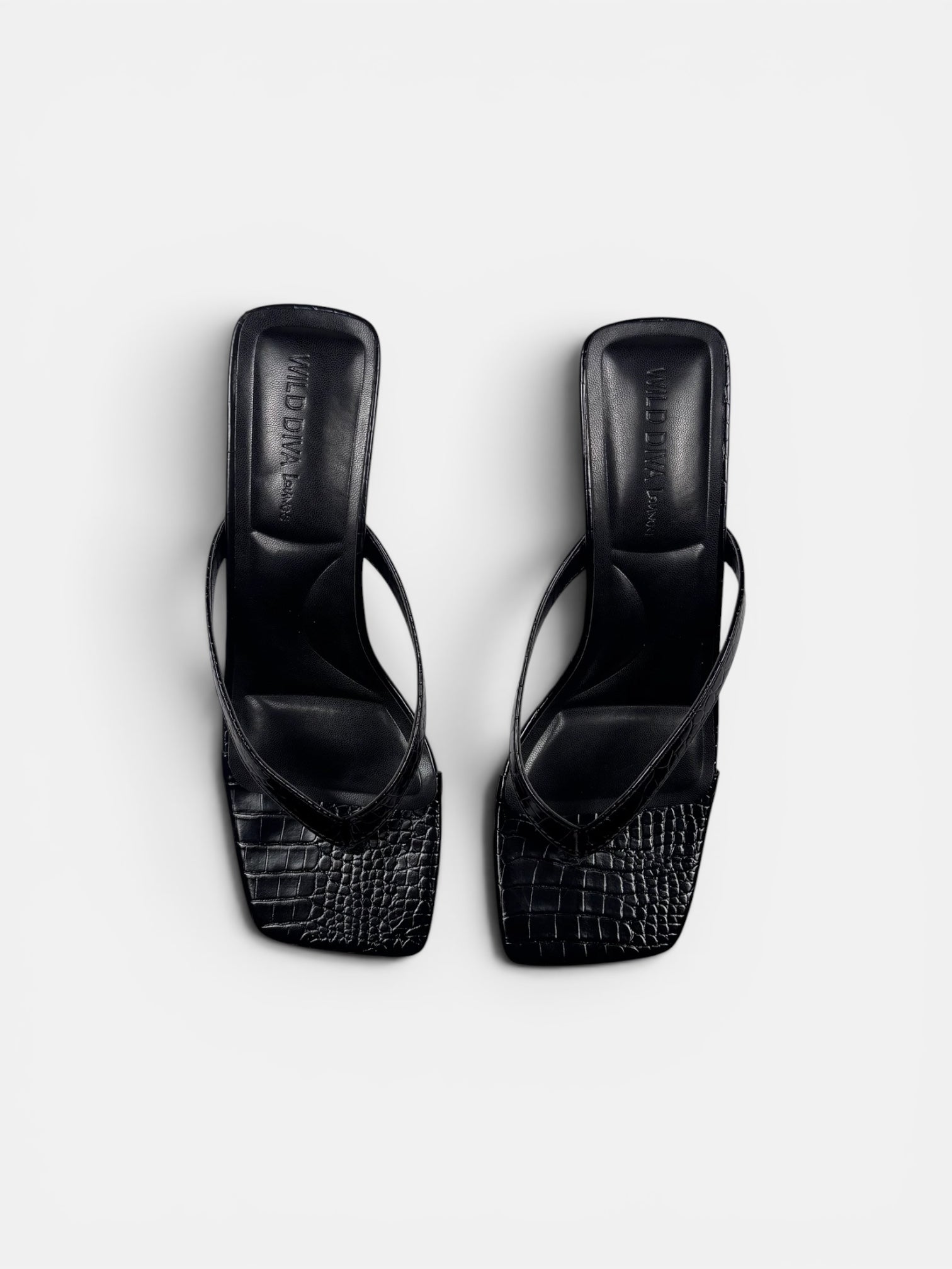 Black crock sandal on a white background