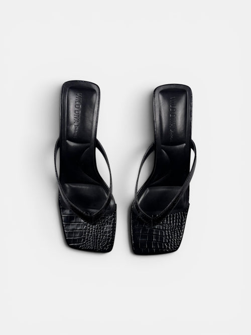 Black crock sandal on a white background
