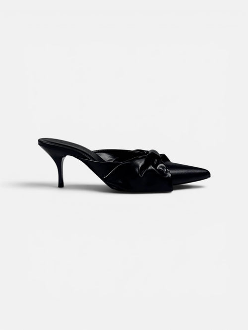 Black high-heeled shoe with a bow on a white background