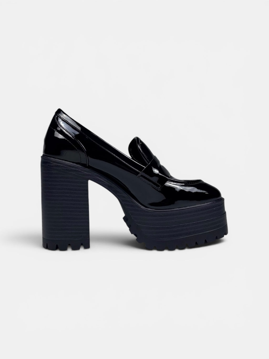 Black platform shoes on a light gray background