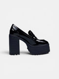 Black platform shoes on a light gray background