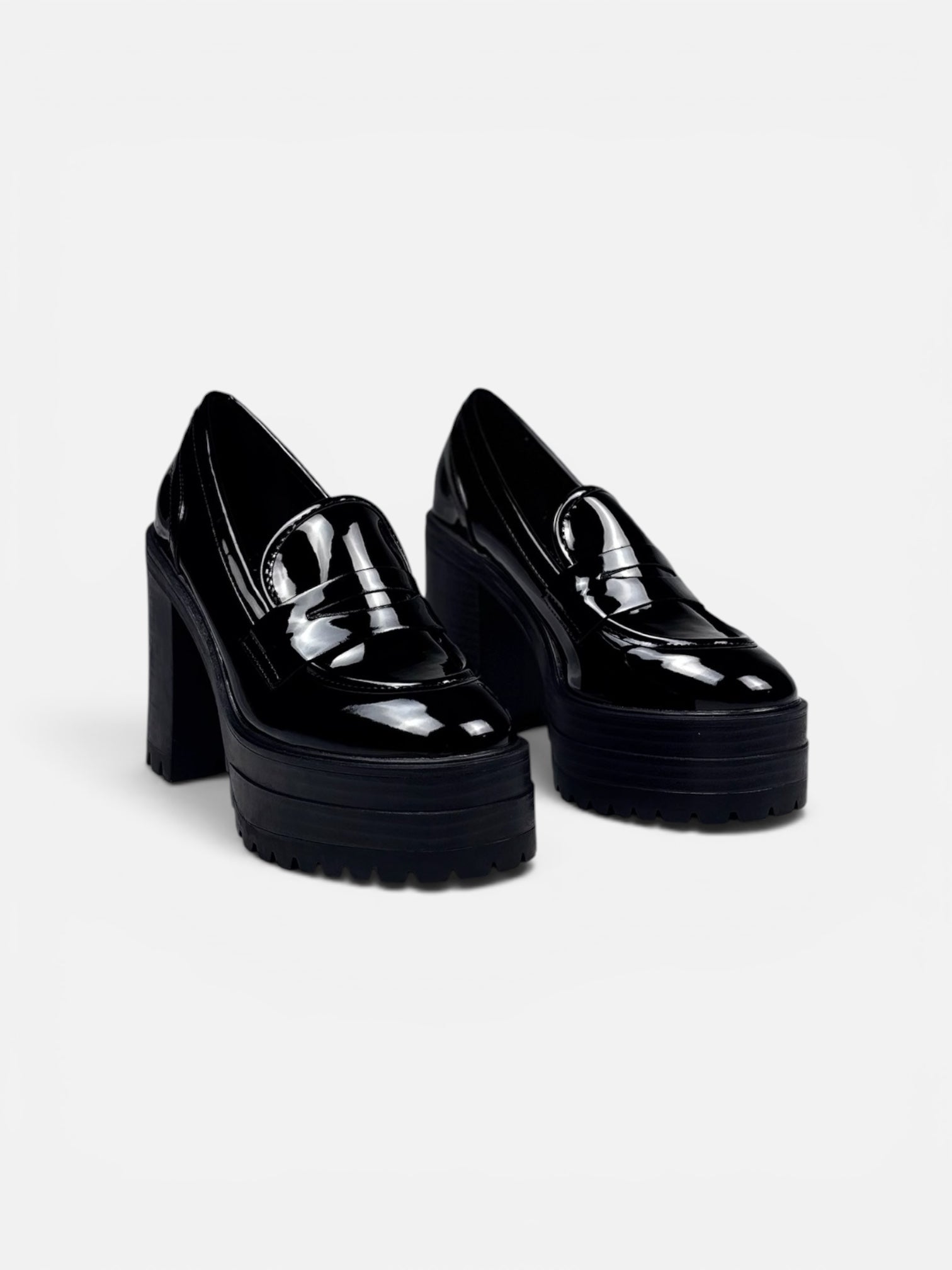 Black platform shoes on a light gray background