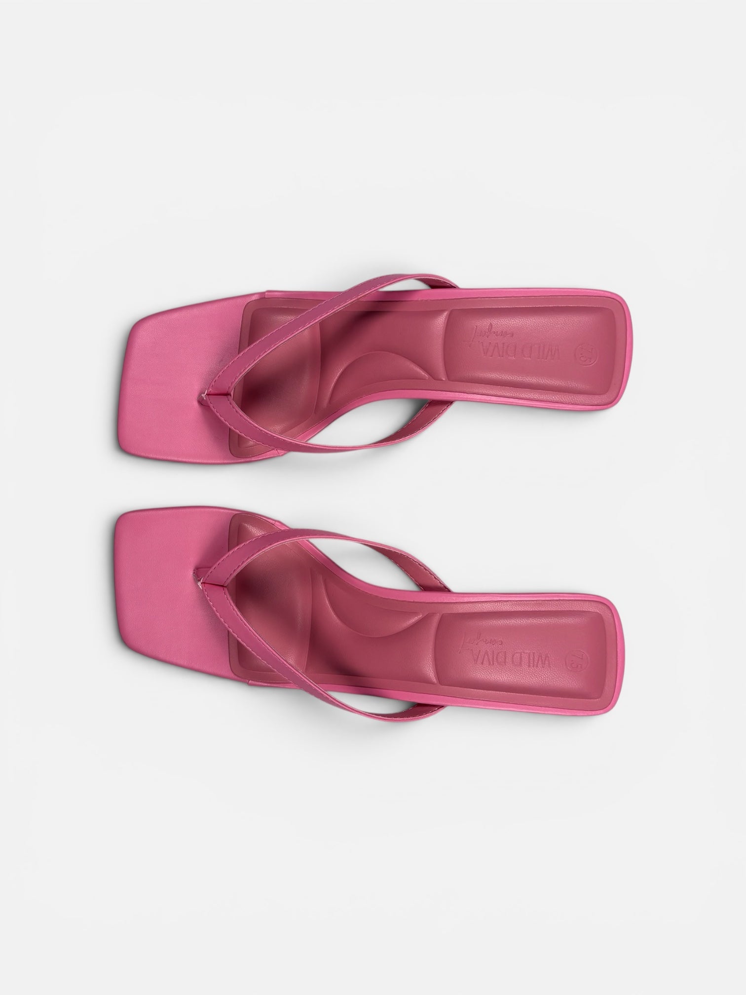 Pair of pink sandals on a light gray background
