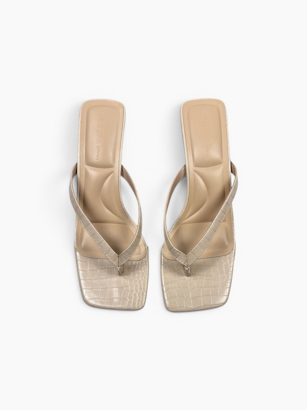 Beige high-heeled sandals with transparent soles on a white background