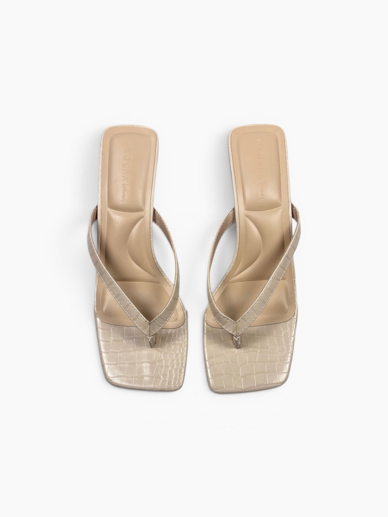 Beige high-heeled sandals with transparent soles on a white background
